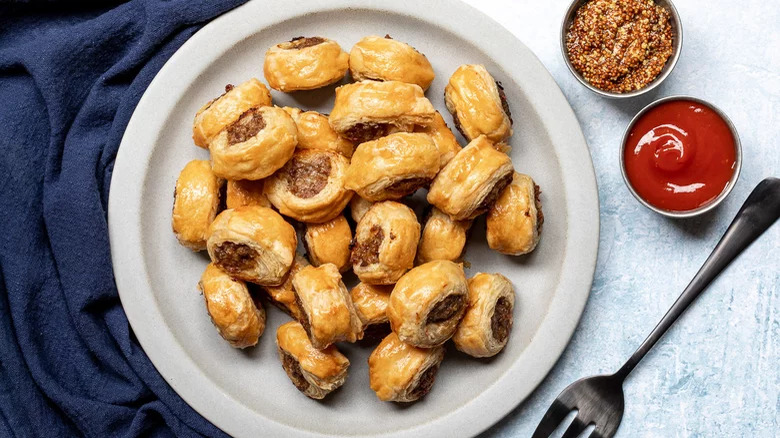 Sausage rolls with ketchup and mustard