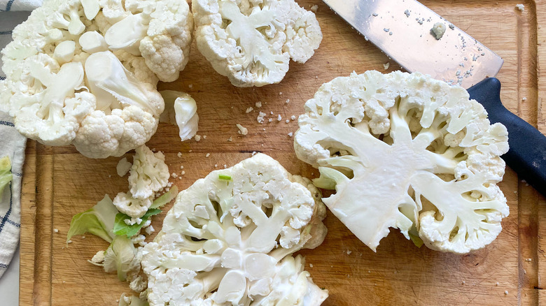 Sliced sections of cauliflower on cutting board
